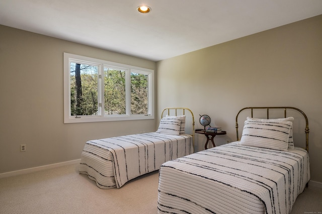 carpeted bedroom featuring baseboards and recessed lighting