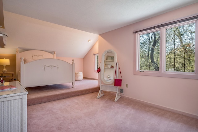 carpeted bedroom featuring baseboards, visible vents, and vaulted ceiling