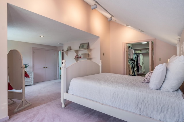 carpeted bedroom with recessed lighting, lofted ceiling, and a closet