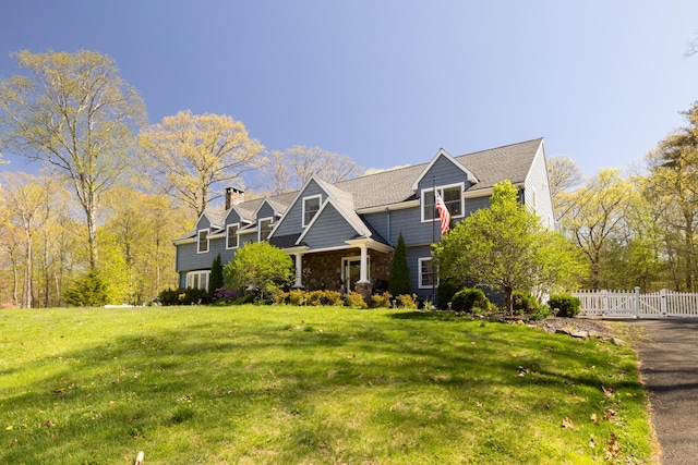 130 Upper Whittemore Rd, Middlebury, CT 06762 - craftsman inspired home featuring a front yard, fence, a chimney, and stone siding
