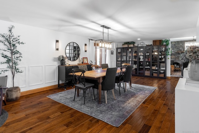 130 Upper Whittemore Rd, Middlebury, CT 06762 - dining space featuring a notable chandelier, hardwood / wood-style flooring, and a wainscoted wall