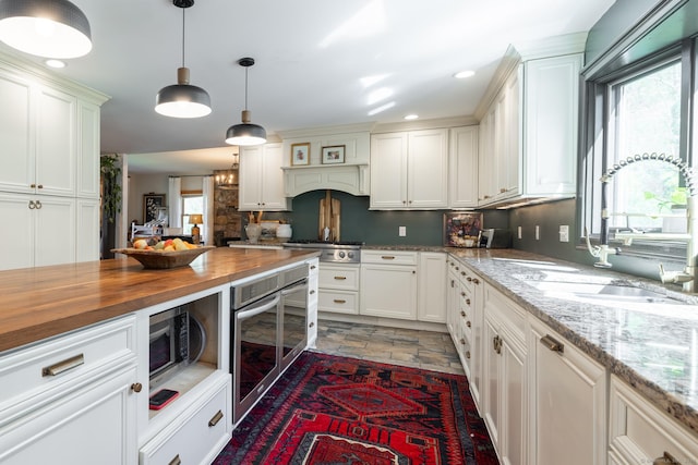 130 Upper Whittemore Rd, Middlebury, CT 06762 - kitchen featuring beverage cooler, stone finish flooring, white cabinetry, a sink, and wood counters