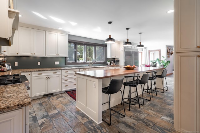 130 Upper Whittemore Rd, Middlebury, CT 06762 - kitchen featuring stone finish floor, recessed lighting, a breakfast bar, and stainless steel built in refrigerator