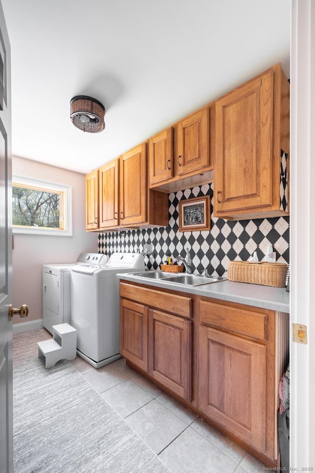 130 Upper Whittemore Rd, Middlebury, CT 06762 - laundry room with washing machine and clothes dryer, cabinet space, a sink, light tile patterned floors, and baseboards