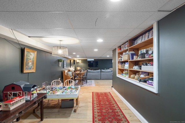 130 Upper Whittemore Rd, Middlebury, CT 06762 - game room with baseboards, a drop ceiling, and light wood-style flooring