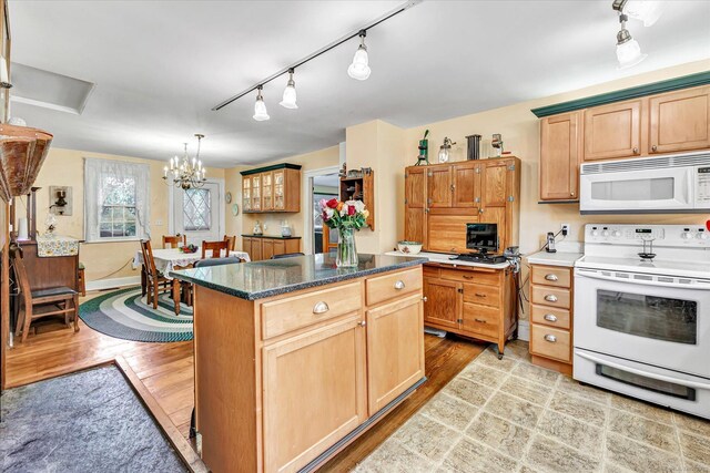 331 Elm St, Monroe, CT 06468 - kitchen with white appliances, light wood-style flooring, rail lighting, a chandelier, and a kitchen island