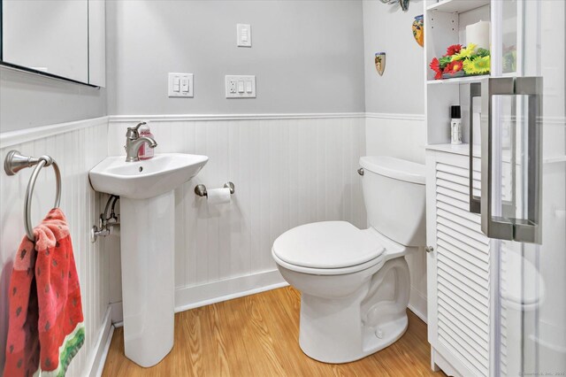 331 Elm St, Monroe, CT 06468 - bathroom with a wainscoted wall, wood finished floors, toilet, and a sink