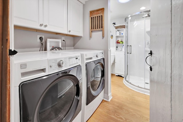331 Elm St, Monroe, CT 06468 - laundry room featuring washer and clothes dryer, light wood-style flooring, and cabinet space