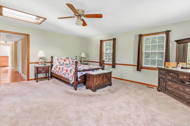 331 Elm St, Monroe, CT 06468 - bedroom with light colored carpet, a skylight, baseboards, and ceiling fan