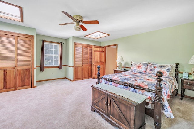 331 Elm St, Monroe, CT 06468 - bedroom with light colored carpet, baseboards, two closets, and a ceiling fan
