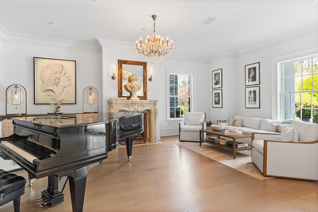 sitting room with light wood-style floors, a notable chandelier, and a healthy amount of sunlight