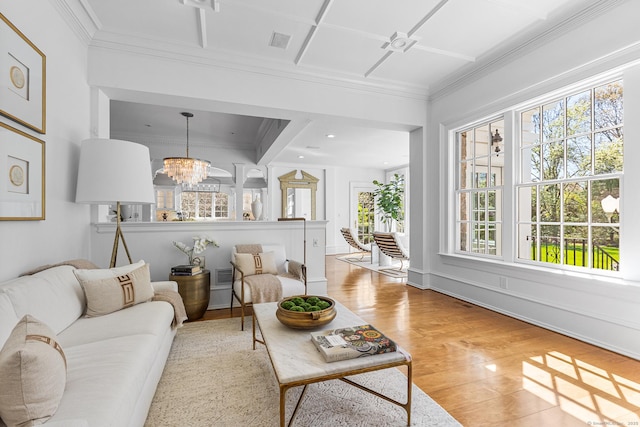 living room featuring ornamental molding, a healthy amount of sunlight, and light wood finished floors
