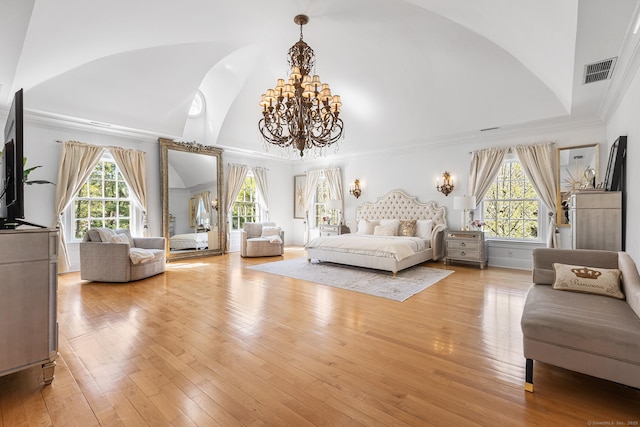 bedroom featuring multiple windows, vaulted ceiling, a chandelier, and visible vents