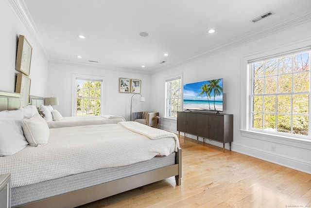 bedroom featuring light wood-style floors and multiple windows