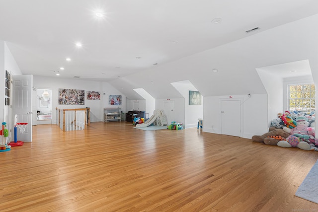 bonus room featuring recessed lighting, lofted ceiling, light wood-type flooring, and visible vents