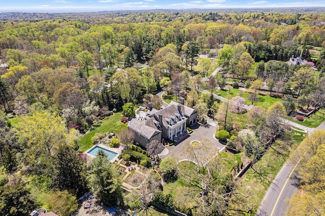 drone / aerial view featuring a forest view