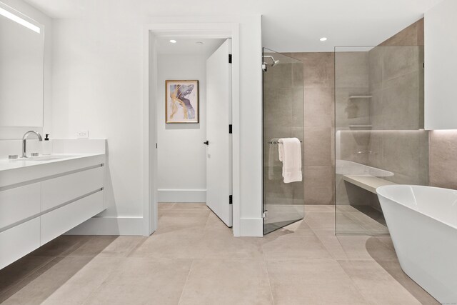 41 Richmondville Ave Unit 206, Westport, CT 06880 - full bathroom featuring vanity, a stall shower, a soaking tub, tile patterned floors, and recessed lighting