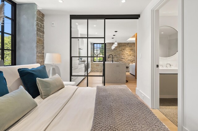 41 Richmondville Ave Unit 206, Westport, CT 06880 - bedroom with light wood-style flooring, a sink, connected bathroom, recessed lighting, and floor to ceiling windows