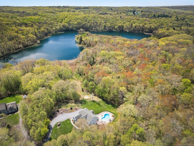 aerial view of property's location featuring a heavily wooded area and a large body of water