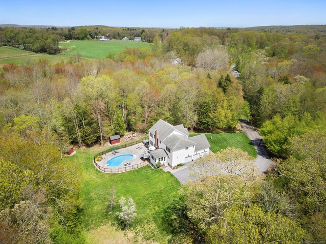 view of subject property featuring a pool area and a heavily wooded area