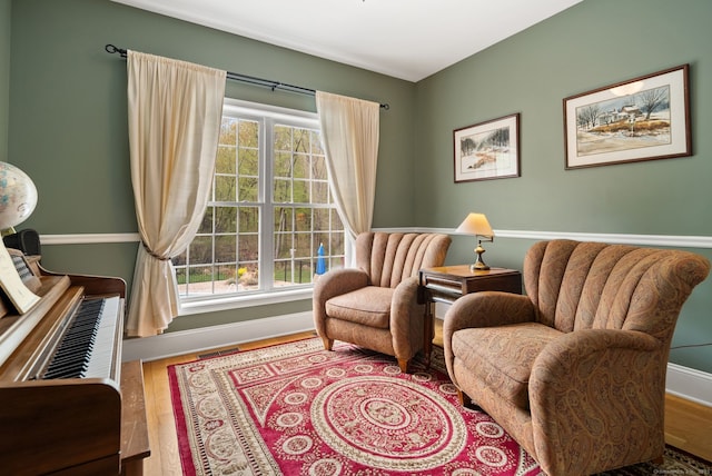 living area featuring baseboards and wood finished floors