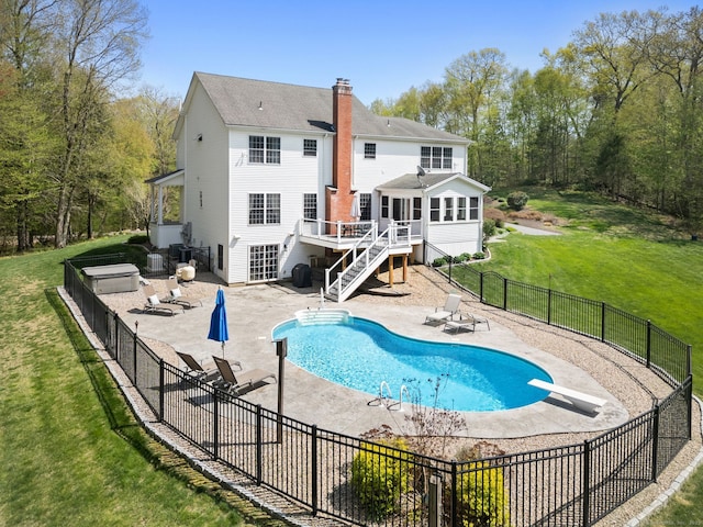 rear view of house featuring a patio area, a chimney, stairway, and a deck