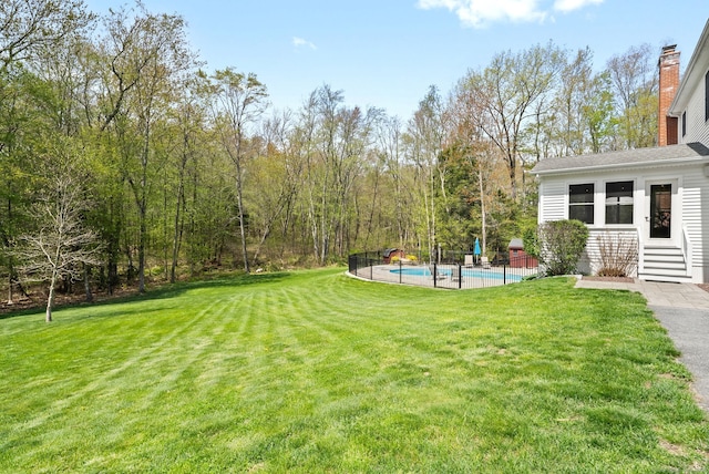 view of grassy yard with entry steps