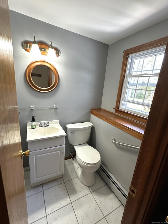 bathroom with vanity, marble finish floor, a baseboard heating unit, and toilet