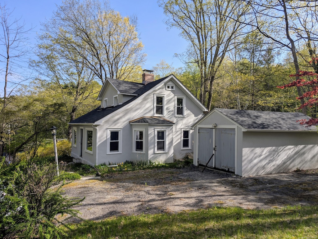 2 Chapel Hill Rd, New Milford, CT 06776 - back of property with a chimney, an outdoor structure, a shed, a shingled roof, and stucco siding