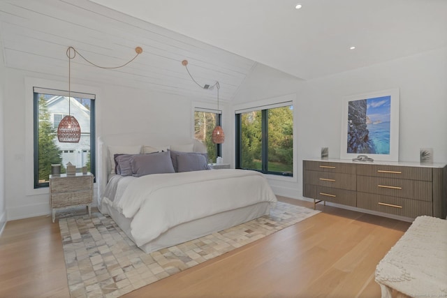 bedroom with baseboards, recessed lighting, light wood-style flooring, and lofted ceiling