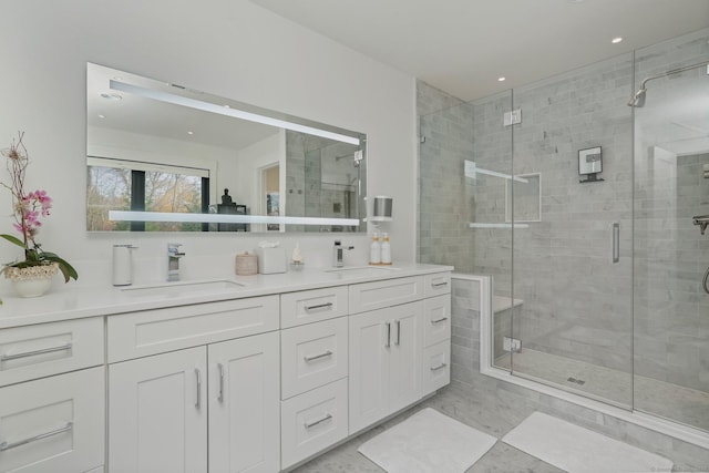full bathroom with a sink, a stall shower, recessed lighting, and double vanity