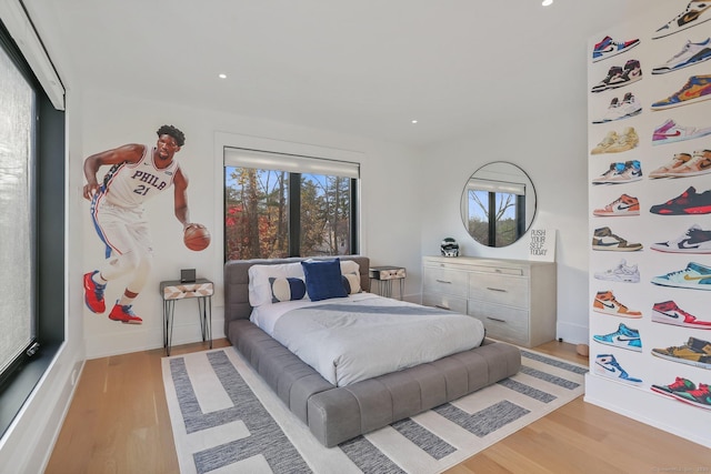 bedroom featuring recessed lighting, light wood-style flooring, baseboards, and white fridge