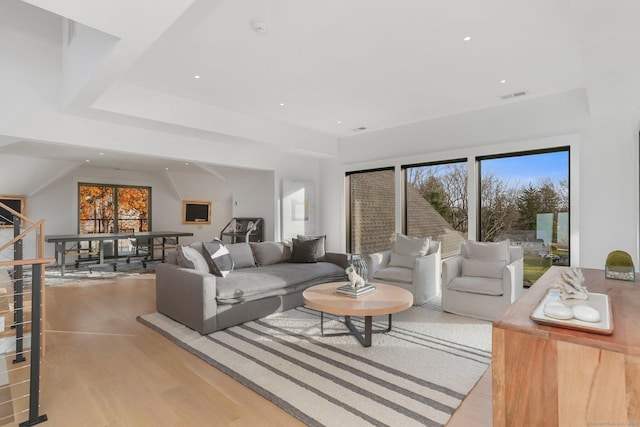living area featuring recessed lighting, visible vents, and wood finished floors