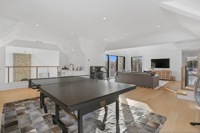 playroom featuring light wood-type flooring, recessed lighting, lofted ceiling, and visible vents