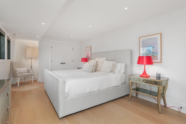 bedroom with recessed lighting, baseboards, a closet, and light wood-type flooring