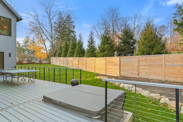 deck with a fenced backyard and a yard