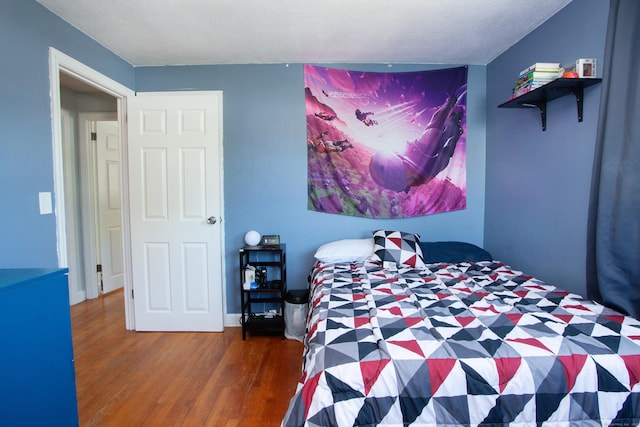 bedroom with wood finished floors