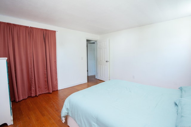 bedroom featuring baseboards and light wood-type flooring