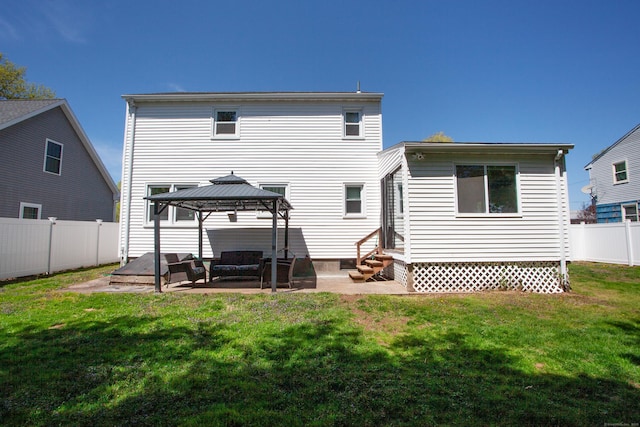 back of house with a patio area, a gazebo, a fenced backyard, a yard, and entry steps