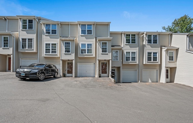 25 Deerwood Ln Unit 8, Waterbury, CT 06704 - view of property featuring an attached garage and driveway