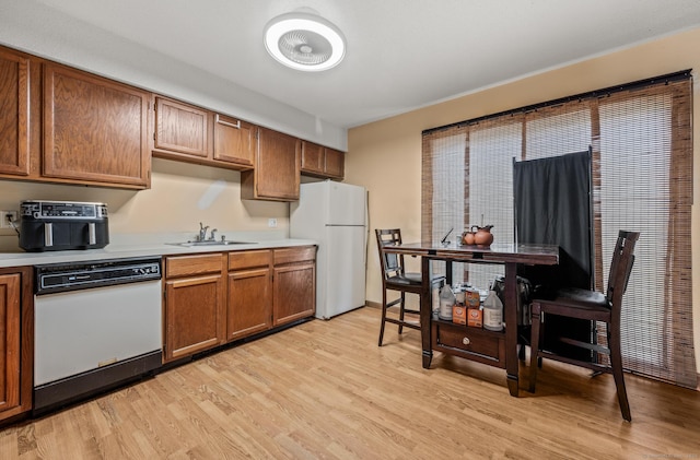 25 Deerwood Ln Unit 8, Waterbury, CT 06704 - kitchen featuring a sink, light countertops, light wood-style floors, and white appliances