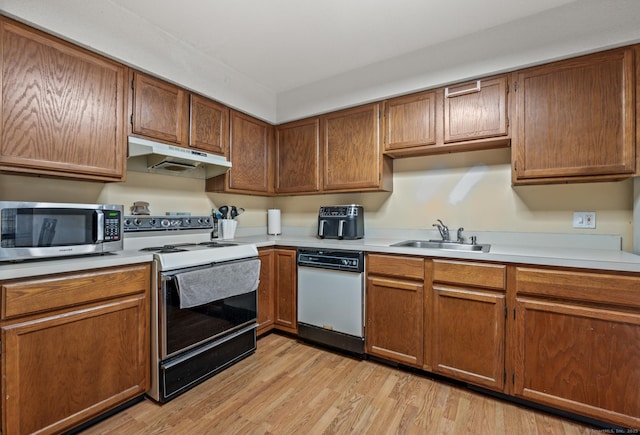 25 Deerwood Ln Unit 8, Waterbury, CT 06704 - kitchen featuring a sink, light wood finished floors, white appliances, light countertops, and under cabinet range hood