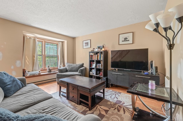 25 Deerwood Ln Unit 8, Waterbury, CT 06704 - living room featuring a textured ceiling, a baseboard radiator, and wood finished floors