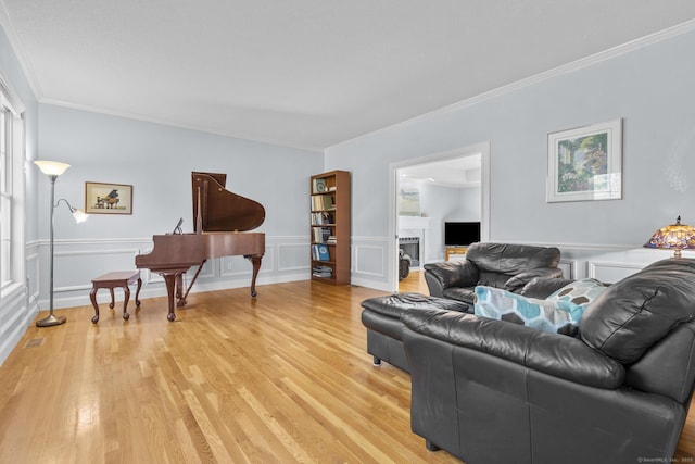 6 Old Farm Rd, Woodbridge, CT 06525 - living area with ornamental molding, a fireplace, wainscoting, and light wood-type flooring