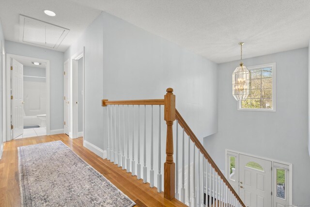 6 Old Farm Rd, Woodbridge, CT 06525 - hallway featuring baseboards, attic access, wood finished floors, and an upstairs landing