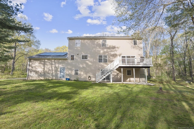 6 Old Farm Rd, Woodbridge, CT 06525 - rear view of property featuring a deck, a patio, roof mounted solar panels, a lawn, and stairway