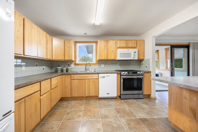149 Heights Dr, Torrington, CT 06790 - kitchen featuring white appliances, a sink, tasteful backsplash, light brown cabinetry, and dark countertops