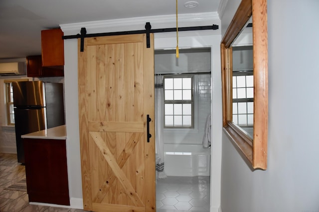 72 Sims St, Bridgeport, CT 06604 - hallway featuring a barn door, a wall unit AC, tile patterned flooring, and baseboards