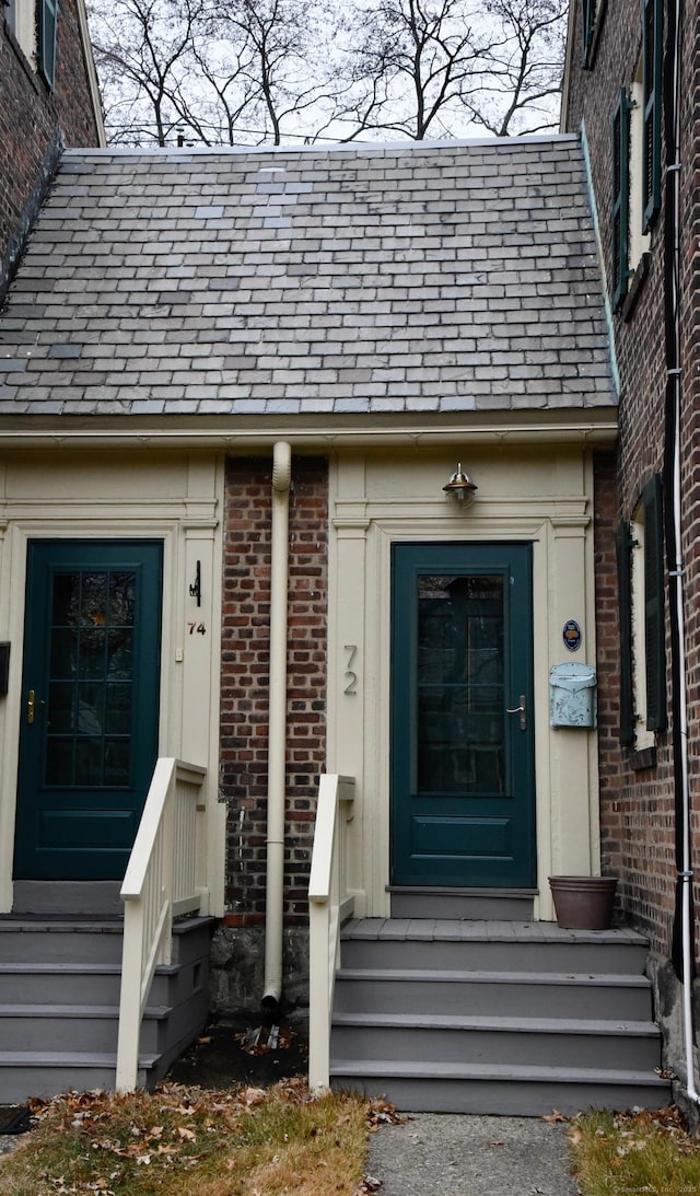 72 Sims St, Bridgeport, CT 06604 - view of exterior entry with brick siding and a high end roof
