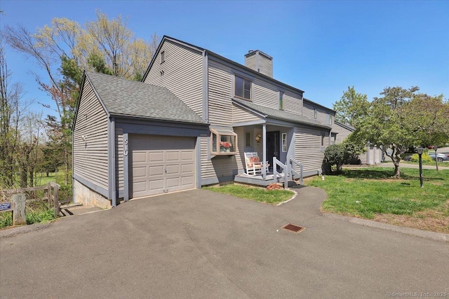 traditional home with a shingled roof, a garage, a front yard, a chimney, and driveway